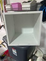 Front view of white cube storage box interior