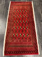 Full view of the Turkman wool rug showing overall design and fringe