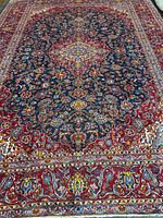 Full view of rug showing overall design, central medallion and borders