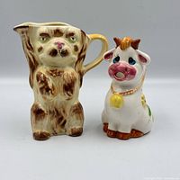 Front view of both ceramic creamers