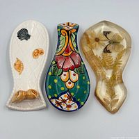 Front view of three spoon rests showing designs