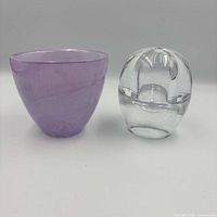 Purple glass votive beside clear glass orb lamp, front view