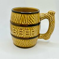 Front view showing raised "BEER" lettering and barrel texture