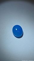 Front view of oval lagoon blue chalcedony cabochon