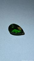 Pear-cut chrome diopside front view showing vivid green color and facets