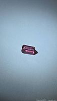 Front view of rectangular pink tourmaline showing cut and color
