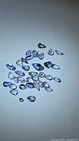 Group of pear-cut tanzanite gemstones on neutral background