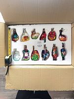 Box with 12 ornaments in foam insert and tape measure reference