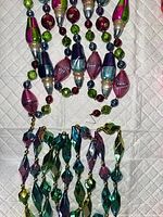 Close view of both multicolor glass bead garlands