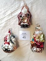 Group shot of three glass Santa ornaments