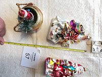 Top view showing all three Santa ornaments with measuring tape for scale