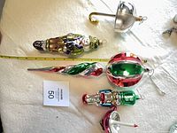 All five ornaments laid out with measuring tape for scale