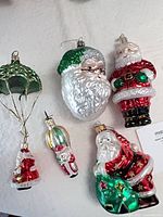 Group shot of all five glass Santa ornaments