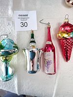 All four blown glass ornaments laid out