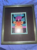 Front view of framed George Littlechild artwork showing image, mat and frame