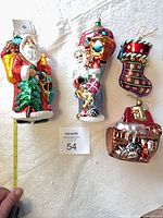 Group shot of four glass ornaments with measuring tape showing scale