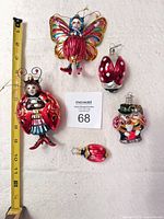 Group view of five ladybug themed ornaments with tape measure for scale