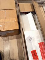 Closed boxes containing West Elm light fixture components