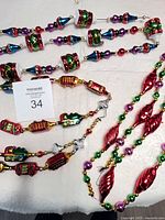 Three Radko glass garlands laid out showing all motifs