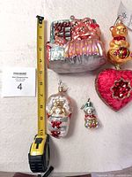 Front view of all four ornaments with measuring tape