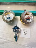 Overview of all three ornaments: two diorama balls and one finial drop