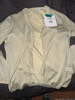 Cardigan laid flat showing front and buttons