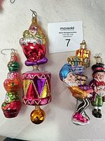 Group view of four figural glass ornaments