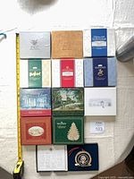 Group shot of boxed ornaments laid out with measuring tape