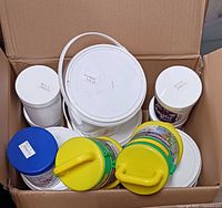 boxed lot showing multiple bait containers and tackle beacons