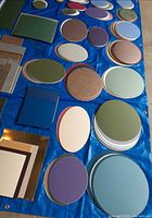 Assorted round, oval and rectangular mat boards spread on tarp