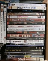 Stack of movie DVDs showing titles such as Mia and the White Lion, Frank & Lola, Chicago, Sex and the City titles, 21 Grams, The Phantom of the Opera, Not Without My Daughter