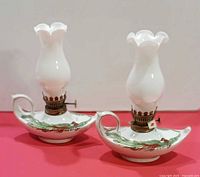 Front view of both ceramic genie-style oil lamps with chimneys attached