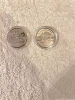 Both coins reverse side showing biplane designs