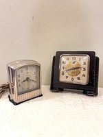Both Art Deco alarm clocks side by side
