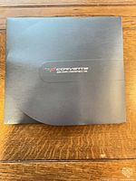 Front of navy presentation folder with Corvette logo and 2008 model text