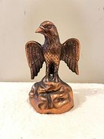 Front view of copper eagle on rock base