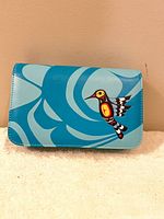 Front of blue purse showing hummingbird graphic