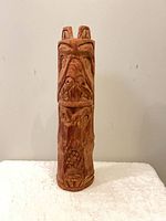 Front view of carved wooden totem pole
