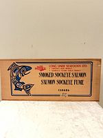 Front view of cedar box showing full printed design and text