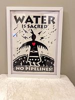 Full view of framed poster standing against wall