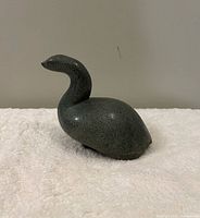 Left-side view of dark green serpentine bird carving