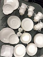 Group overview of dinnerware pieces including cups, bowls, plates, shakers
