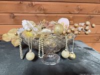 Crystal pedestal bowl with gold and white decorative arrangement front view