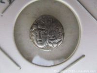 Obverse with dual inverted Apollo portraits