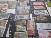 Overview of multiple banknotes in plastic sleeves