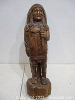 Front view of carved wooden Indigenous chief statue