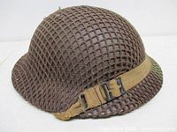 Side profile showing full shell, netting and chinstrap