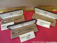 Three Cross pens each in original case with booklet displayed