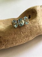 Top view of gold ring showing three blue oval stones