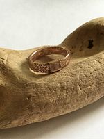 Ring front view on carved wood prop